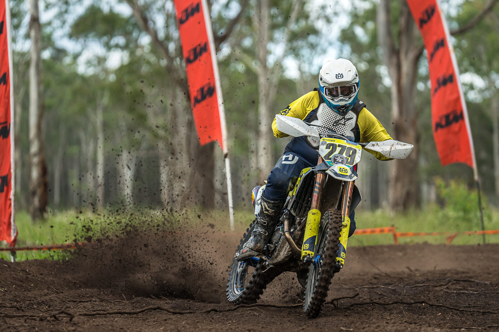 Husqvarna rider between KTM Racing flags